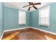 Bright bedroom featuring hardwood floors, a ceiling fan, and natural light from two windows at 2110 Cokey Rd, Rocky Mount, NC 27801