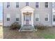 Close-up of the home entrance with a decorative front door and columned portico at 2110 Cokey Rd, Rocky Mount, NC 27801