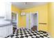 Kitchen featuring a black-and-white checkered floor and bright yellow walls at 2110 Cokey Rd, Rocky Mount, NC 27801