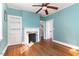 Cozy living room featuring hardwood floors, a fireplace, built-in shelving, and bright natural light at 2110 Cokey Rd, Rocky Mount, NC 27801