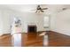 Bright living room with fireplace, hardwood floors, and a door to the outside at 2110 Cokey Rd, Rocky Mount, NC 27801