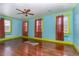 Light-filled living room with vibrant blue walls, hardwood floors, and abundant natural light at 2110 Cokey Rd, Rocky Mount, NC 27801