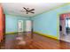 Spacious living room featuring hardwood floors, ceiling fan, and multiple windows with a bright, airy feel at 2110 Cokey Rd, Rocky Mount, NC 27801
