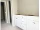 Bathroom featuring white cabinetry with doors and drawers plus modern round pulls and neutral walls at 212 Fast Pitch Ln, Four Oaks, NC 27524
