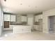 Open-concept kitchen with white cabinets, center island, and modern layout, ready for customization and appliances at 212 Fast Pitch Ln, Four Oaks, NC 27524