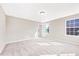 Bright bedroom with plush carpet, neutral walls, and natural light from a large window at 212 Wildwood Ln, Graham, NC 27253