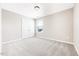 Carpeted bedroom featuring a double door closet and a large window at 212 Wildwood Ln, Graham, NC 27253