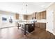 Modern kitchen with granite counters, stainless appliances, and a center island at 212 Wildwood Ln, Graham, NC 27253