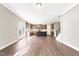 Open kitchen featuring granite countertops, stainless steel appliances, and hardwood floors at 212 Wildwood Ln, Graham, NC 27253