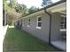 The exterior of this house is painted grey and has large windows with white trim at 216 Clayton St, Rocky Mount, NC 27803