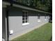 The exterior of this house is painted grey and has large windows with white trim at 216 Clayton St, Rocky Mount, NC 27803