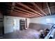 Unfinished basement with exposed beams, offering potential for customization at 2305 Poole Rd, Raleigh, NC 27610