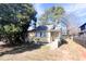 Cozy yellow home exterior with front yard and a combination of leafy and bare trees at 2305 Poole Rd, Raleigh, NC 27610