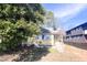 A charming exterior view of a yellow house with a yard and various trees at 2305 Poole Rd, Raleigh, NC 27610