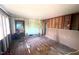 Renovated living room showcasing exposed walls, original flooring, and ample space at 2305 Poole Rd, Raleigh, NC 27610