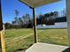 Backyard view from the back porch showcasing a wide green yard and distant treeline at 24 Heatherglenn Cir, Princeton, NC 27569
