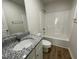 Bathroom featuring granite countertop vanity, tiled backsplash, and a shower-tub combo at 24 Heatherglenn Cir, Princeton, NC 27569