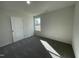 Cozy bedroom featuring neutral carpet, a window, and a closet door for storage at 24 Heatherglenn Cir, Princeton, NC 27569