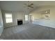 Bright living room with a cozy fireplace, plush carpet, and ample natural light from large windows at 24 Heatherglenn Cir, Princeton, NC 27569