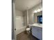 Bright, tiled bathroom with a shower-tub combination and white vanity at 242 Deodora Ln, Cameron, NC 28326