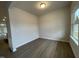 Sunlit room with windows, neutral paint, and laminate flooring, offering a versatile space at 242 Deodora Ln, Cameron, NC 28326