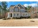 Charming two-story home with gray siding, white trim, landscaped yard, and an American flag displayed on the porch at 2504 Georgianna Dr, Wake Forest, NC 27587