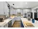 A modern kitchen with grey cabinetry, stainless steel appliances, and a contrasting blue island at 2504 Georgianna Dr, Wake Forest, NC 27587