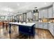 Bright kitchen features a large center island with marble countertop, custom cabinets, and hardwood flooring at 2504 Georgianna Dr, Wake Forest, NC 27587