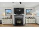 Inviting living room with fireplace, large windows providing scenic views, and stylish sideboards flanking the fireplace at 2504 Georgianna Dr, Wake Forest, NC 27587