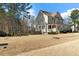 Side view of home with fenced in area; view of flag on front porch, large yard, with mature trees at 2504 Georgianna Dr, Wake Forest, NC 27587