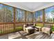 Screened-in porch with comfortable seating and panoramic views of the surrounding landscape at 2504 Georgianna Dr, Wake Forest, NC 27587