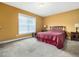 Comfortable bedroom featuring soft carpet, a window, and elegant bedside tables at 2574 Primrose Ln, Creedmoor, NC 27522