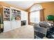 Bedroom featuring neutral carpet, custom built-ins, and a large window at 2574 Primrose Ln, Creedmoor, NC 27522