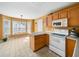 Bright kitchen with breakfast nook, white appliances, and a view of the backyard at 2574 Primrose Ln, Creedmoor, NC 27522