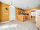 Efficient kitchen layout with laminate flooring, wooden cabinets, and access to the dining area at 2574 Primrose Ln, Creedmoor, NC 27522