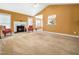 Open concept living room with fireplace, high ceilings, and neutral carpet at 2574 Primrose Ln, Creedmoor, NC 27522