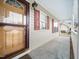Inviting porch features a storm door and traditional red shutters at 2574 Primrose Ln, Creedmoor, NC 27522