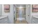 A bathroom with a glass enclosed shower, double sink vanity, and modern decor at 268 Sweetbay Tree Dr, Wendell, NC 27591