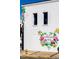 Building featuring a colorful mural with flowers, butterflies, and the words 'Spread Love Wendell, NC' at 268 Sweetbay Tree Dr, Wendell, NC 27591