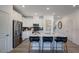 Modern kitchen with white cabinets, stainless steel appliances, black backsplash, and a center island with bar stool seating at 268 Sweetbay Tree Dr, Wendell, NC 27591