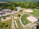 Aerial view showcasing community sports fields, playground, community center, and parking area at 270 Sweetbay Tree Dr, Wendell, NC 27591