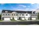 Charming townhome exteriors feature stone accents, neutral siding, and attached garages for a modern look at 270 Sweetbay Tree Dr, Wendell, NC 27591