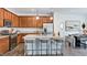 Well-equipped kitchen with wood cabinets, granite countertops, and a central island with bar seating at 270 Sweetbay Tree Dr, Wendell, NC 27591