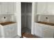 Unfinished kitchen featuring white cabinets and drywall, showcasing a spacious layout awaiting final touches at 277 Gregory Village Dr, Lillington, NC 27546
