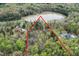 Expansive aerial view of a home site featuring a large lake, mature trees, and custom home at 292 Choice Trl, Pittsboro, NC 27312