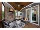 Inviting screened-in porch with stone fireplace, comfortable seating, and backyard views at 292 Choice Trl, Pittsboro, NC 27312