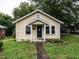 Charming, light yellow bungalow with a cozy front porch and green front door at 318 Mcmasters St, Chapel Hill, NC 27516