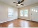 Bright living room featuring hardwood floors, large windows, and a modern ceiling fan at 318 Mcmasters St, Chapel Hill, NC 27516