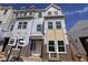 New construction townhome with brick and siding exterior awaiting finishing touches, under a bright blue sky at 324 Chesapeak Commons St # 143, Garner, NC 27529