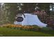 A decorative welcome sign surrounded by colorful flowers marks the community entrance at 324 Chesapeak Commons St # 143, Garner, NC 27529